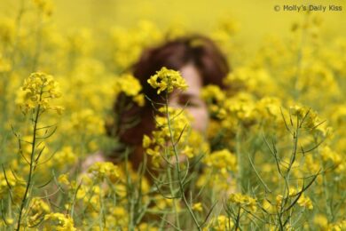 crouching in rapeseed field naked