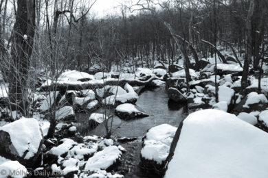 Rocks in the creek at St Peter's Village PA covered in snow