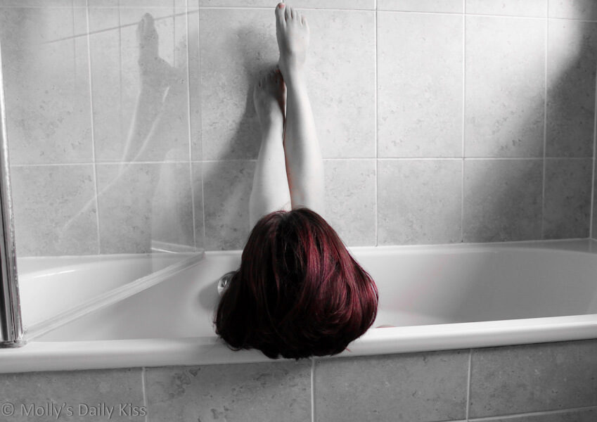 Molly sitting in the bath with red hair