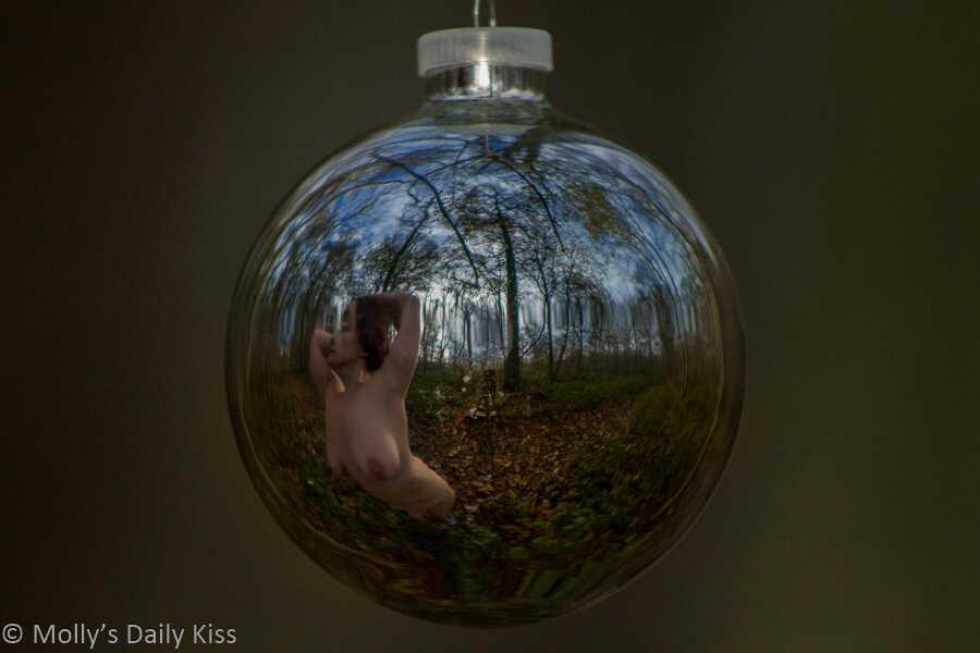 Molly naked in the woods reflection in christmas bauble