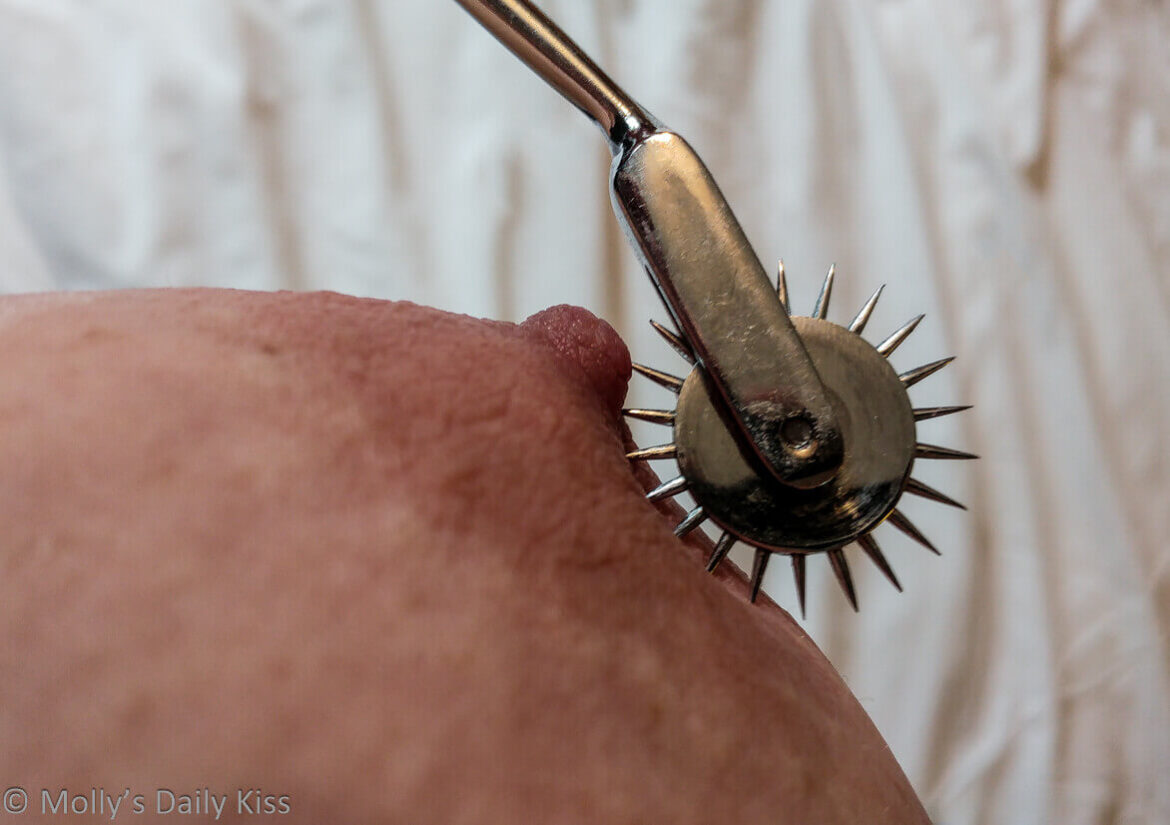 Macro shot of pinwheel running over molly's nipple
