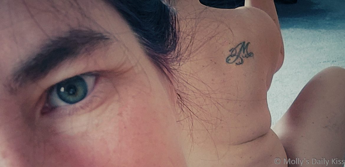 Mtattoo2022crop Cropped image showing Molly's M is for Molly tattoo and her green eye looking into the camera