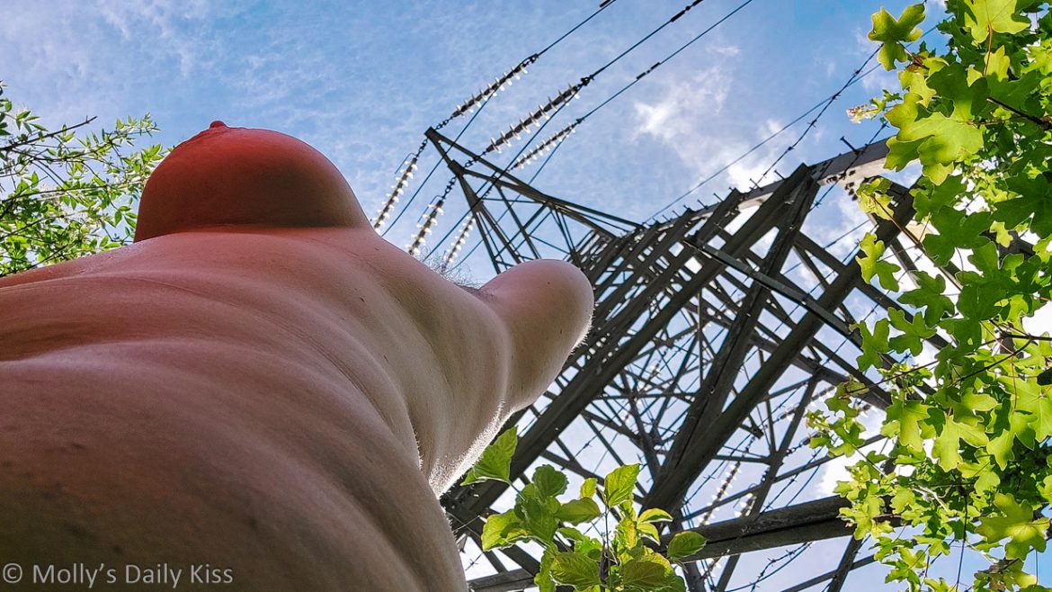 Looking up Molly's body to electricity pylon abover her head