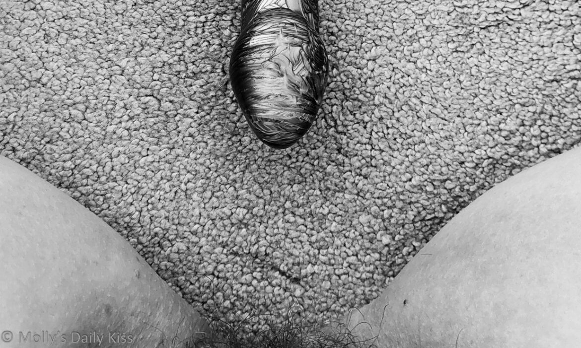 Cropped image of head of dildo pointing to Molly's pubic hair for post called directions